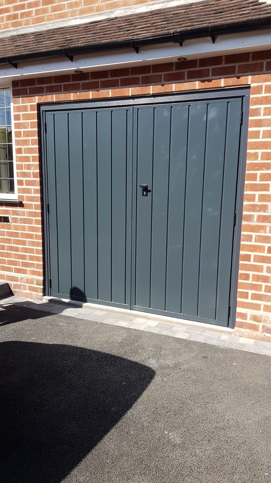 Anthracite grey side hinged garage door.