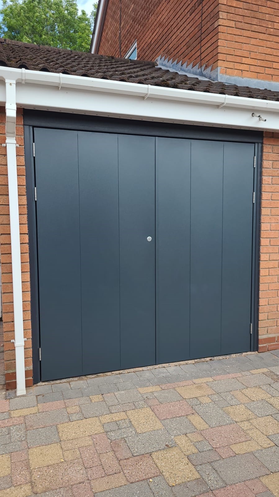 Gisburn style grey side hinged garage door.